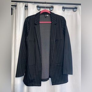 Slightly oversized black blazer with small white pinstripes